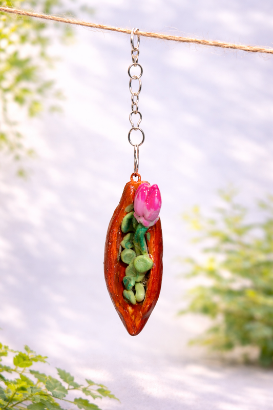 Handmade blooming seed pod clay keychain designed as a botanical bag charm and nature-inspired accessory