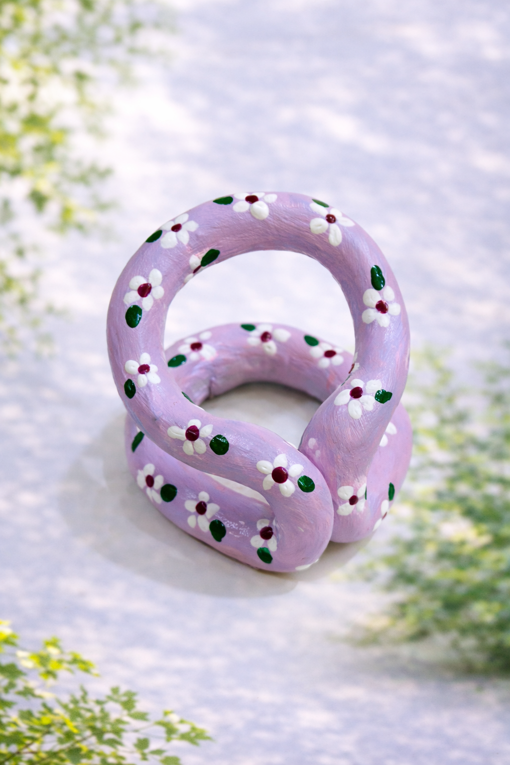 Handmade lilac daisy chain sculpture crafted from clay, styled as aesthetic floral table decor and cottagecore home accessory