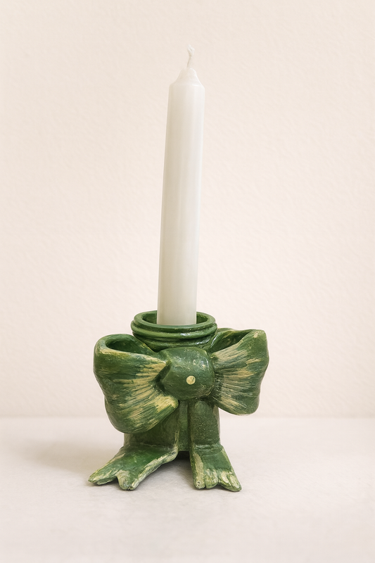 Handmade green bow-shaped clay candle holder designed for taper candles, styled as coquette-inspired aesthetic table decor